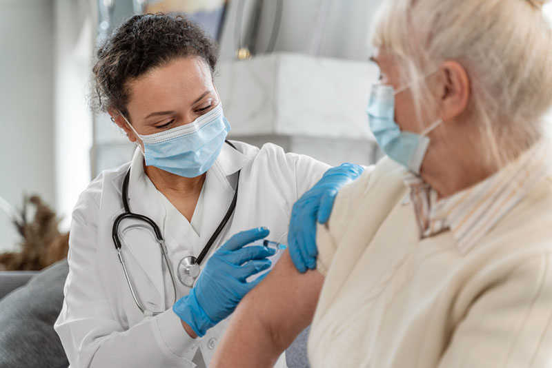 γιατρός εμβολιάζει ασθενή με το εμβόλιο κατά της γρίπης