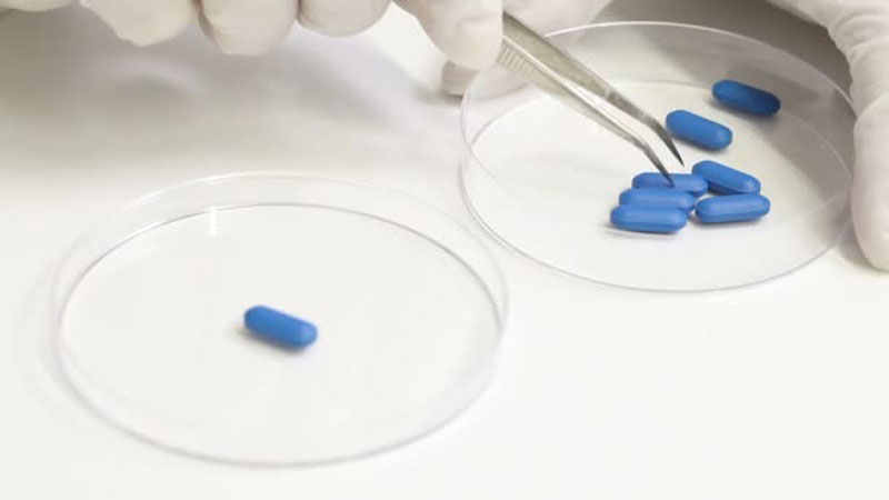 ερευνητής εξετάζει χάπια στο εργαστήριο