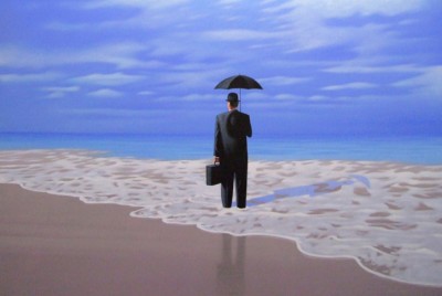 άνδρας με κουστούμι κρατάει ομπρέλα στην παραλία